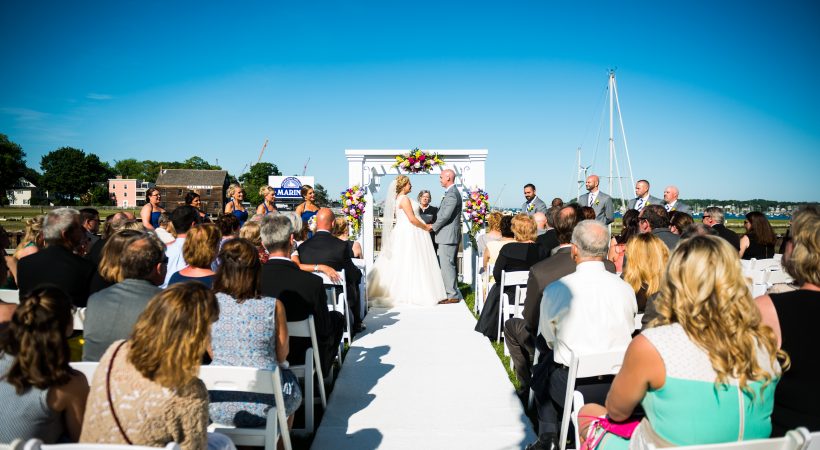 An outdoor wedding ceremony at Pickering Wharf a the Salem Waterfront Hotel & Suites.